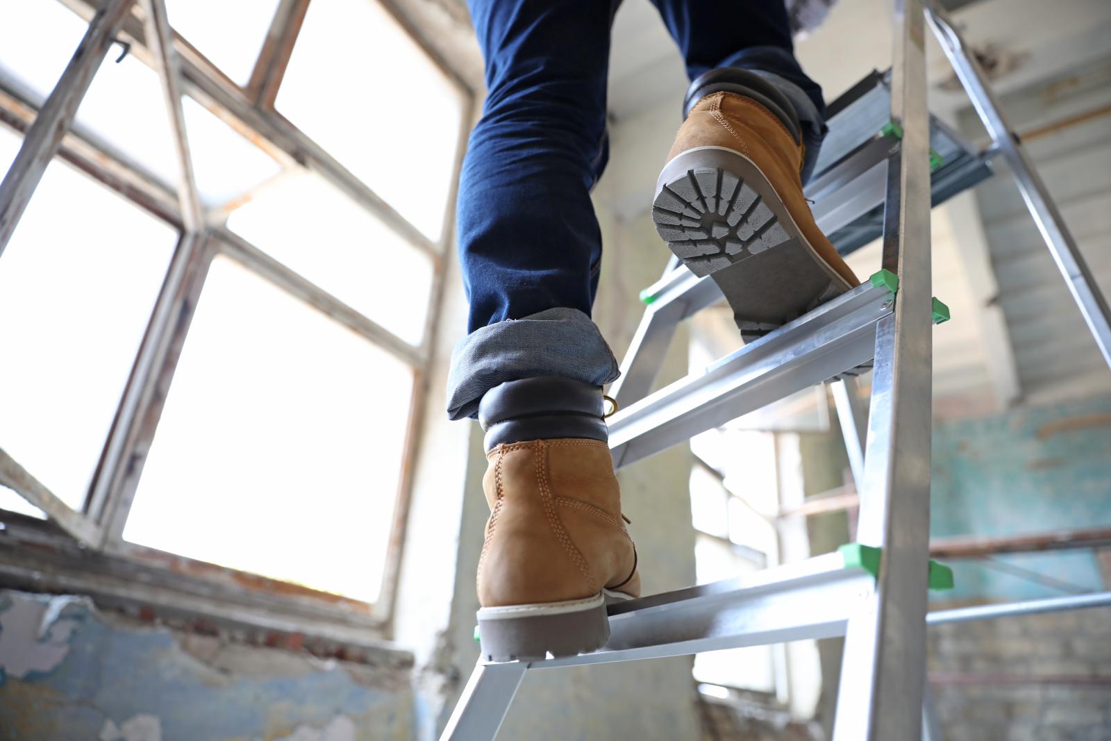Image of an individual climbing a ladder.